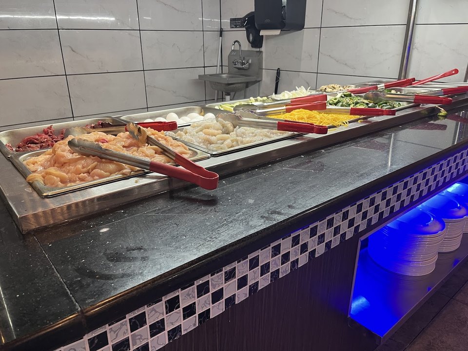 Hibachi station with fresh ingredients ready for grilling.